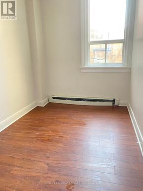 Barrie (City Centre) multi-family for rent - A room with a window and a radiator on the floor.