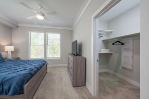 Columbus apartment for rent - A bedroom with a bed, dresser, and a television.