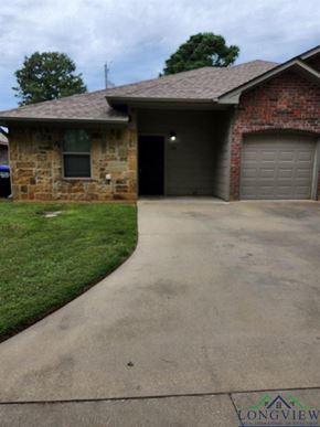 Longview apartment for rent - A brick house with a driveway in front.