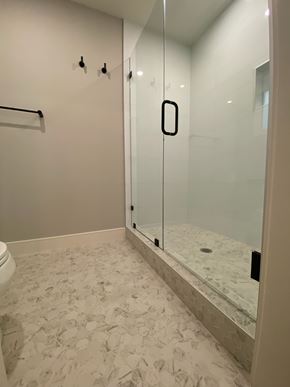 San Diego house for rent - A white bathroom with a glass shower door.