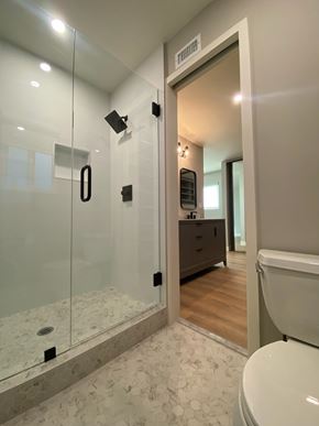 San Diego house for rent - A bathroom with a glass shower stall and a toilet.