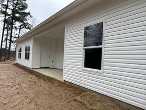 Benton house for rent - A white house with a brown door and windows.