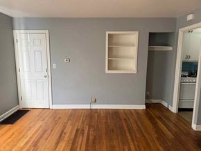 Rockford apartment for rent - A room with wooden floors and a white door.