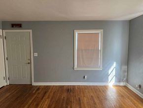 Rockford apartment for rent - A room with a wooden floor and a white door.