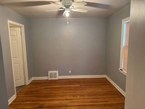 Rockford apartment for rent - A room with a ceiling fan and a wooden floor.