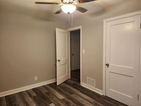 Rockford house for rent - A room with a ceiling fan and two doors.