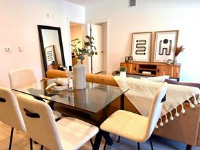 Vancouver apartment for rent - A dining room with a glass table and chairs.