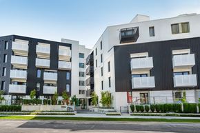 Vancouver apartment for rent - A modern apartment complex with black and white buildings.