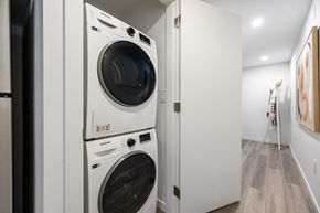 Vancouver apartment for rent - A white washing machine and dryer stacked on top of each other in a small laundry room.