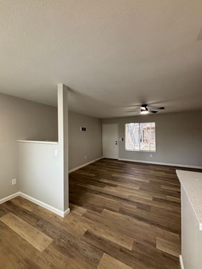 San Diego apartment for rent - A room with wooden flooring and a ceiling fan.