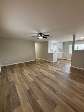 San Diego apartment for rent - A room with wooden flooring and a ceiling fan.