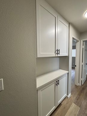 San Diego apartment for rent - A kitchen with white cabinets and a light brown floor.