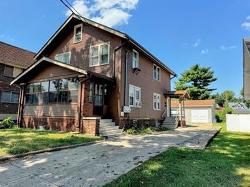Rockford apartment for rent - A house with a brown brick exterior and a white garage door.