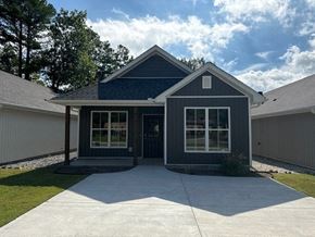 Little Rock house for rent - A house with a dark blue exterior and a white garage door.