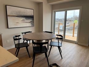 Kanata apartment for rent - A dining room with a round table and four chairs.