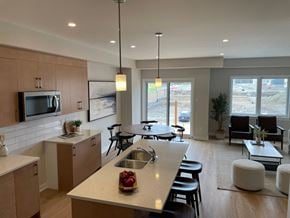 Kanata apartment for rent - A modern kitchen with a dining area and a view of an outdoor construction site.