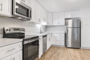 Wheaton apartment for rent - A kitchen with white cabinets and stainless steel appliances.