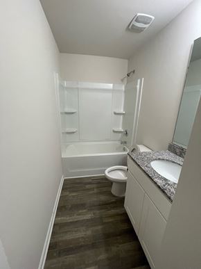 Rocky Mount house for rent - A white bathroom with a toilet, sink, and bathtub.