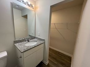 Rocky Mount house for rent - A bathroom with a sink, mirror, and toilet.