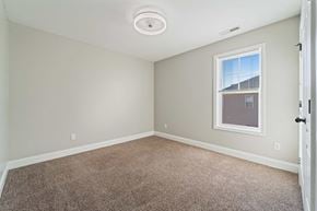 Jacksonville house for rent - A room with a carpeted floor and a window showing a building outside.