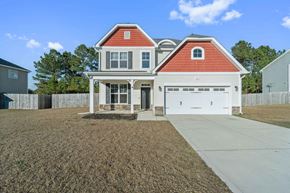 Jacksonville house for rent - A two-story house with a red roof and white walls.