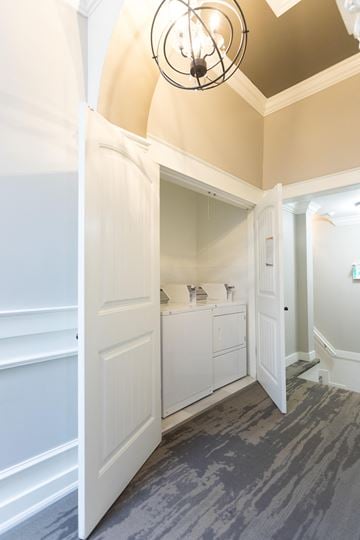 Pembroke apartment for rent - A white kitchen with a grey floor and a chandelier.