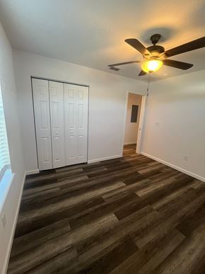 St. Augustine apartment for rent - A room with a ceiling fan and a wooden floor.