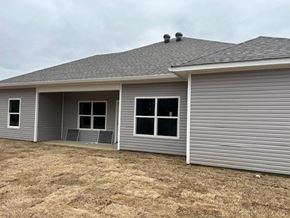 Benton house for rent - A grey house with a grey roof and grey siding.