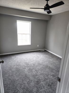 Cleveland house for rent - A room with a ceiling fan and a window.