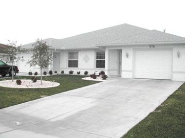 Cape Coral apartment for rent - A white house with a grey roof and a grey concrete driveway.