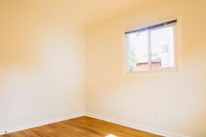 Oakland apartment for rent - A room with a window and wooden floors.