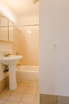 Oakland apartment for rent - A white sink with a white bathtub in a bathroom.