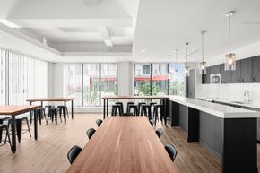 Lucan apartment for rent - A modern dining room with a long wooden table and black chairs.