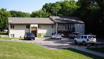 Melrose apartment for rent - A house with a driveway and cars parked in front.