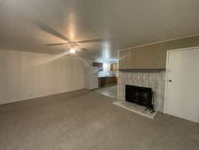 Anchorage apartment for rent - A living room with a fireplace and a ceiling fan.