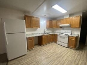Anchorage apartment for rent - A kitchen with white appliances and wooden cabinets.