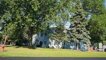 Richmond apartment for rent - A white building with a green lawn in front.