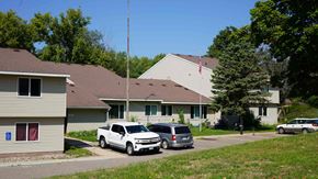 Holdingford apartment for rent - A white car is parked in front of a house.