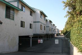 Anaheim apartment for rent - A row of houses with a gate in front.