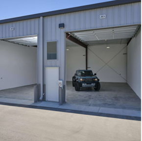 Boise apartment for rent - A black jeep is parked in a garage with a white door.