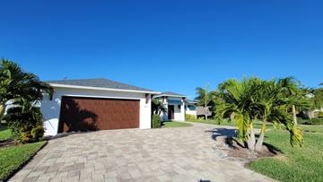 Cape Coral house for rent - A house with a driveway and a garage.