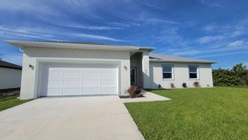 Cape Coral house for rent - A modern house with a white garage door.