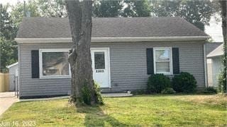 Owensboro house for rent - A small house with a white door and a tree in front.