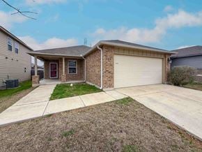 San Antonio house for rent - A house with a red door and a garage door.