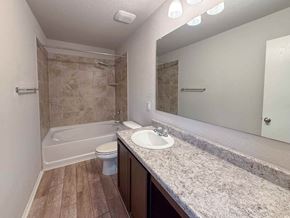 San Antonio house for rent - A bathroom with a marble countertop and a walk-in shower.
