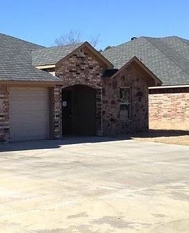 Longview apartment for rent - A house with a garage door and a driveway.