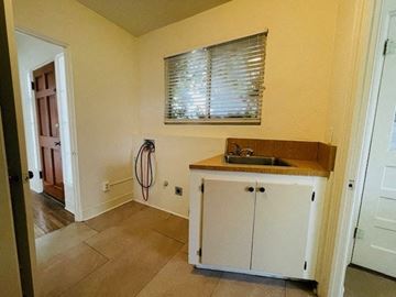 Las Cruces house for rent - A kitchen with a sink and cabinets.