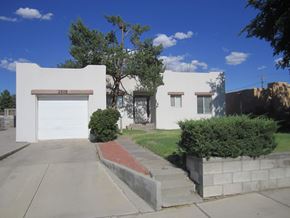 Las Cruces house for rent - A white house with a brown garage door numbered 2503.