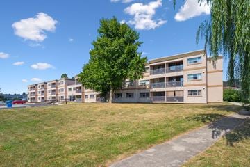 Kitchener apartment for rent - A large grassy area in front of apartment buildings.