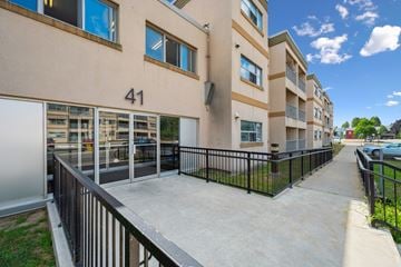 Kitchener apartment for rent - Apartment building number 41 with a black railing and a concrete walkway.